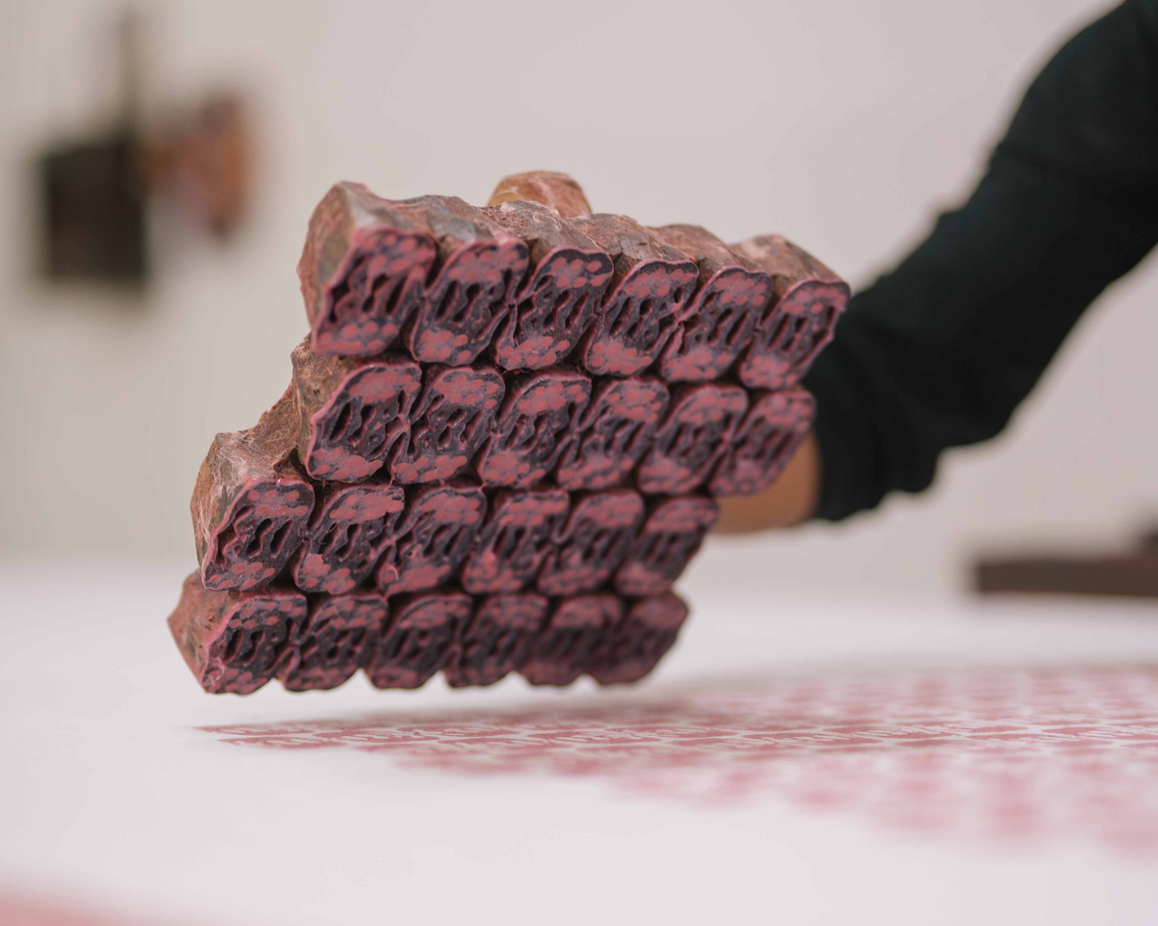 Love brand Elephant of India block printing tool. Wooden block printing block covered in pink dye.