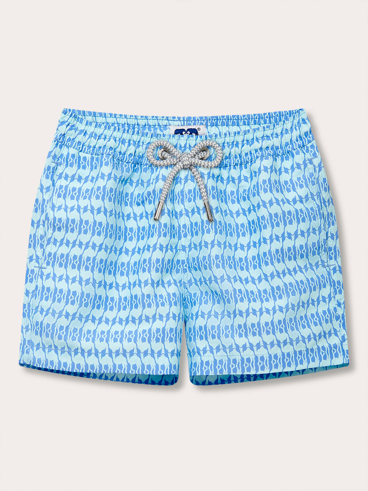 Boys Camel Mirage Sky Staniel Swim Shorts featuring a light blue print with camel silhouettes, drawstring waist, and contrasting white and blue braided drawstring.