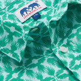 Close-up of Boys Palm Eagle Abaco Linen Shirt showcasing green tropical palm leaves and eagles design with brand label and buttons.