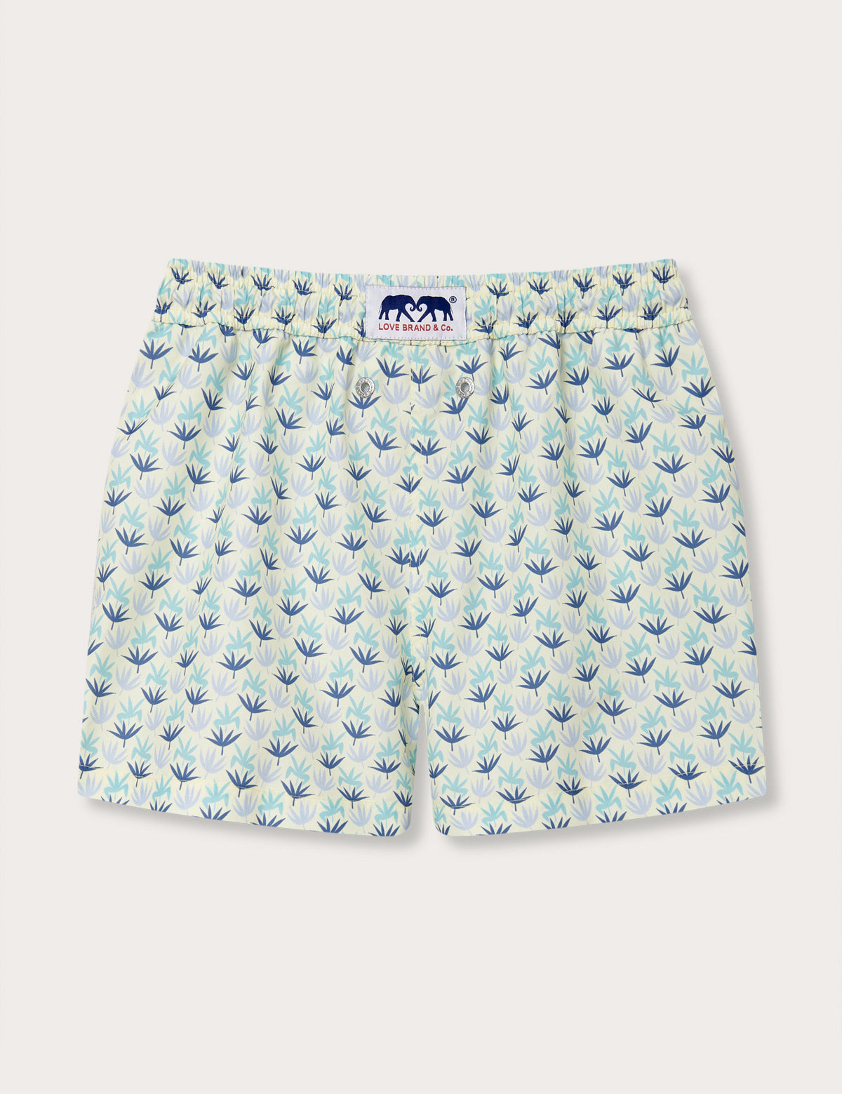 Boys palm sugar staniel swim shorts with a bright, vibrant tropical fan palm design on a limoncello yellow background with sky blue, aqua green, and deep blue accents.