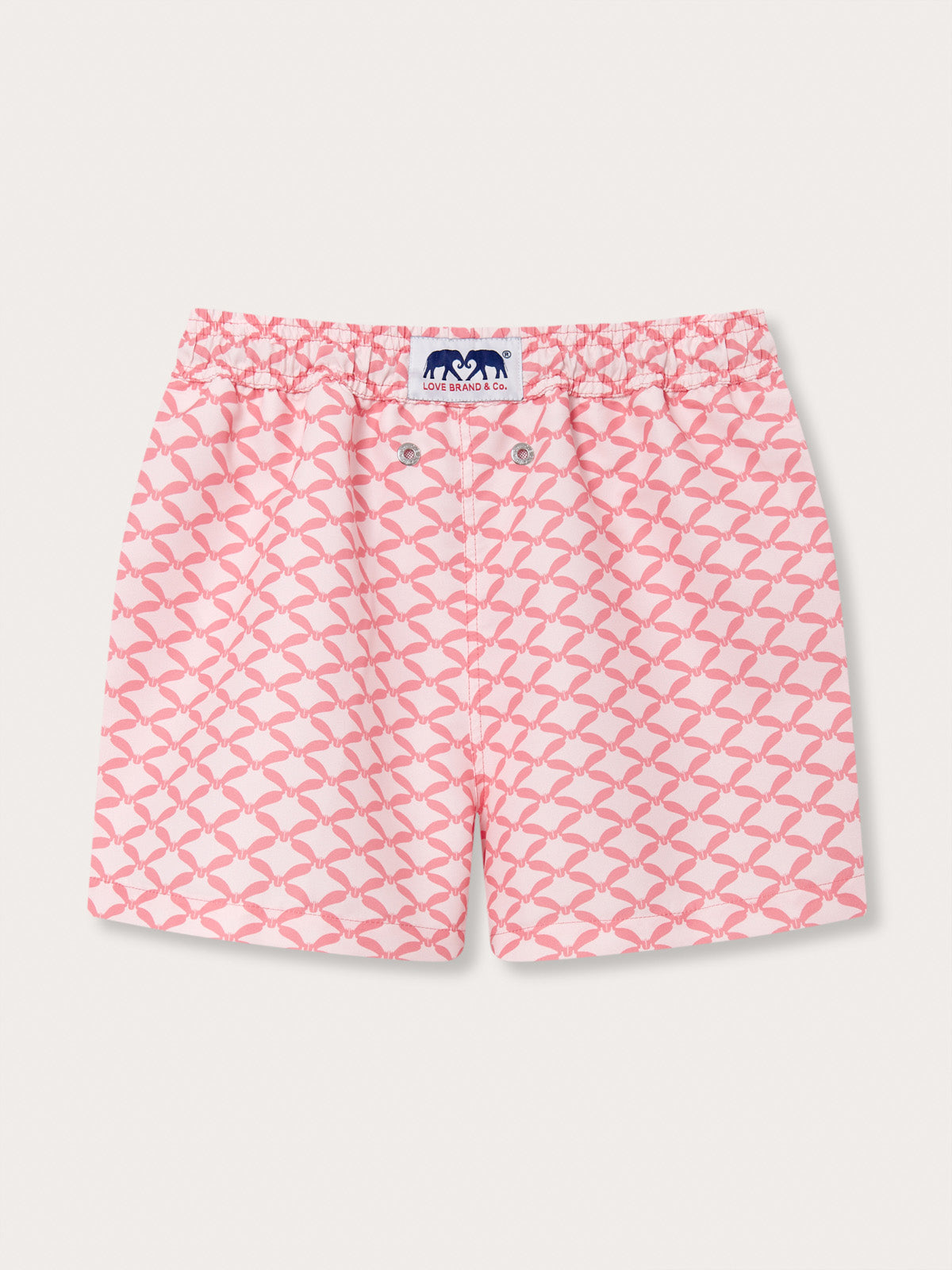 Pink swim shorts for boys with diamond geometric print of grand manta rays in watermelon and light pink; branded with Love Brand & Co.