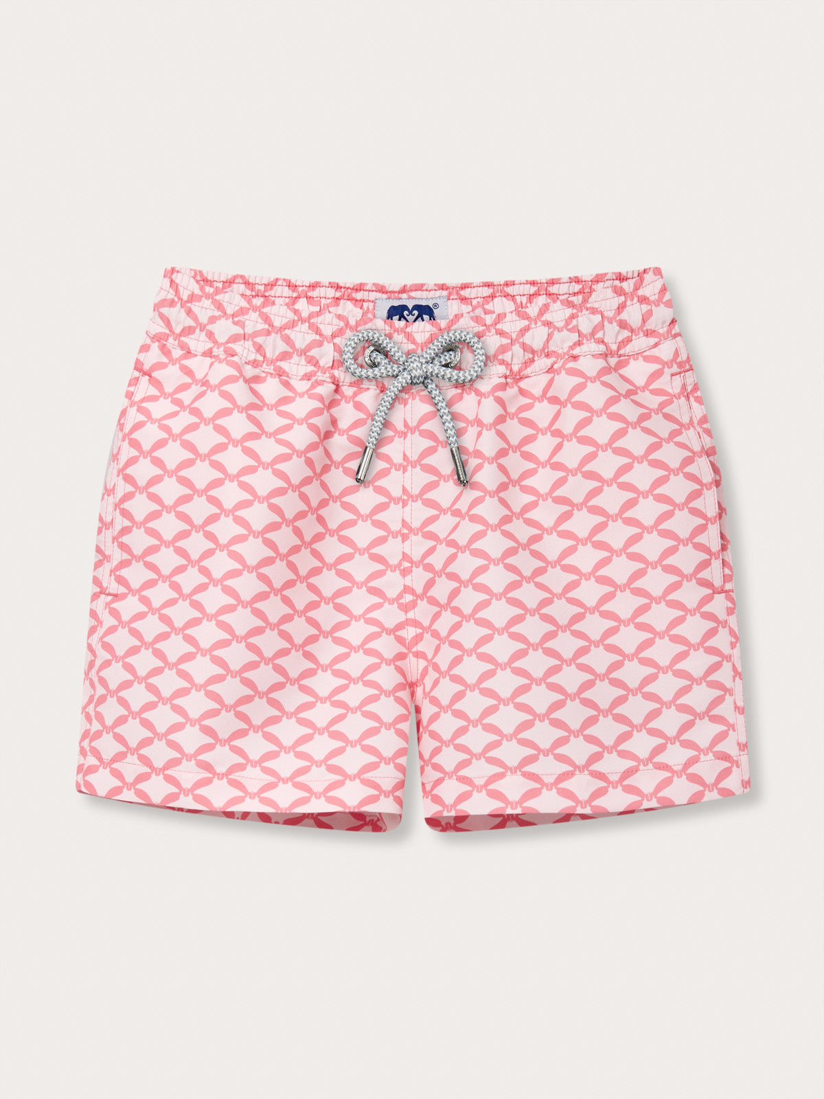 Boys' pink and white geometric print swim shorts with a bow design.