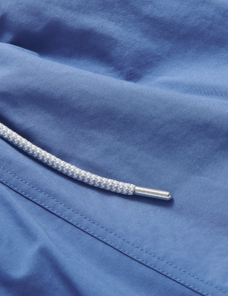 Men's Deep Blue Staniel Swim Shorts close-up. Blue plain swim shorts featuring drawstring.