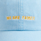 Sky blue cotton peak cap with 'We Are Family' embroidery on the front.