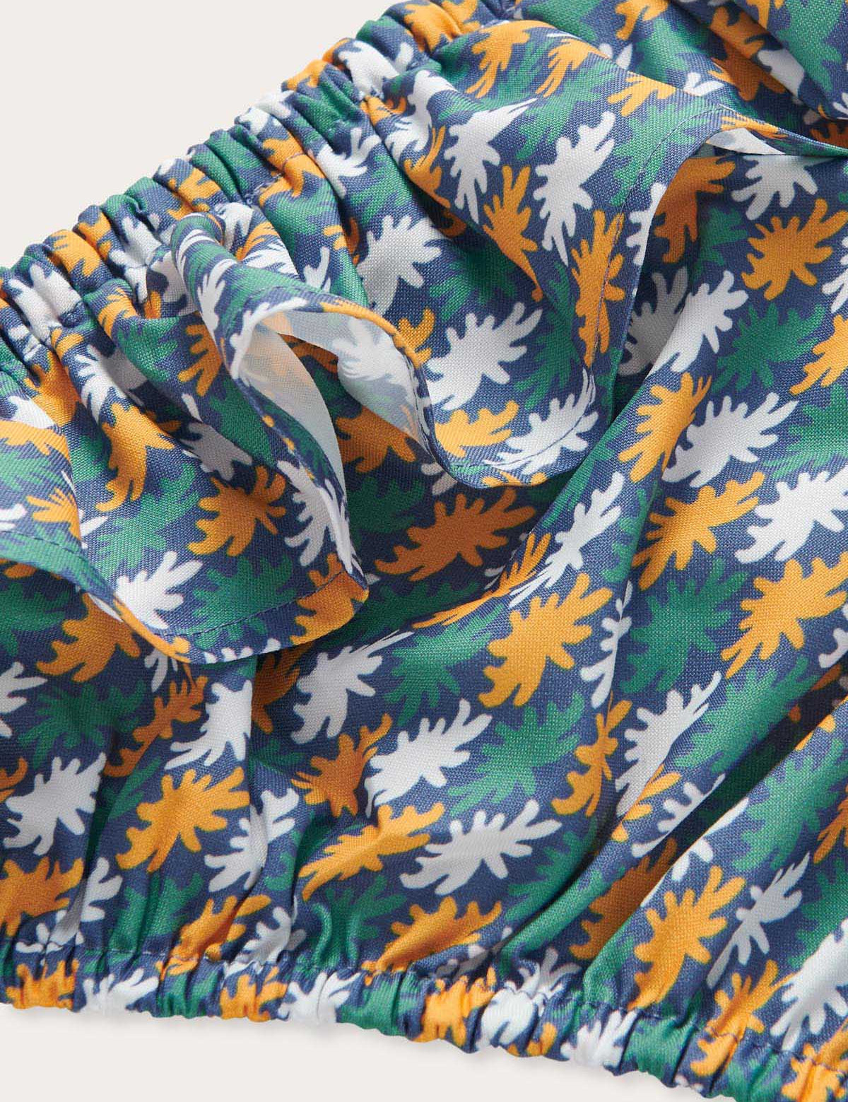 Girls Sea Flowers Calabash Baby Bottoms with vibrant seafloor floral design in yellow ochre, white, and green on a deep blue base, crafted from 100% recycled materials, and featuring quick-drying fabric.