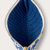 Quilted clutch bag with Elephant Palace Blue print, featuring a gold zipper and blue quilted interior.