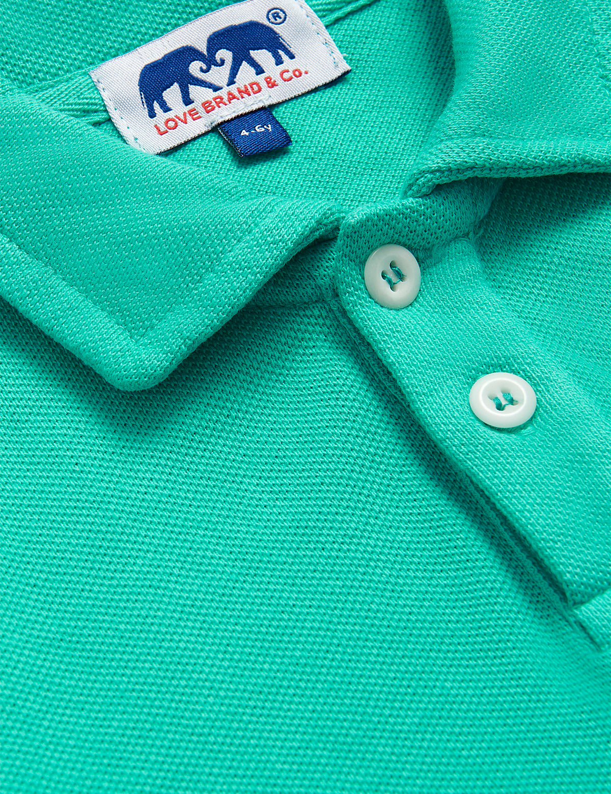 Close-up of a Sicilian Green Pensacola Polo Shirt for boys showcasing the debonair collar, branded buttons, and the durable cotton texture.