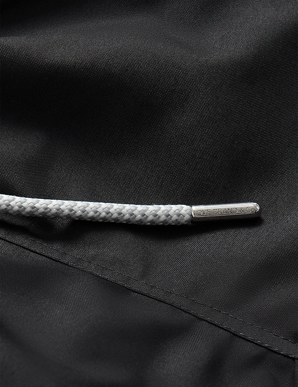 Close-up of drawstring and fabric of Boys Volcanic Black Staniel Swim Shorts.