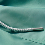 Close-up view of Boys Riviera Green Staniel Swim Shorts detailing quick-dry fabric and drawstring.