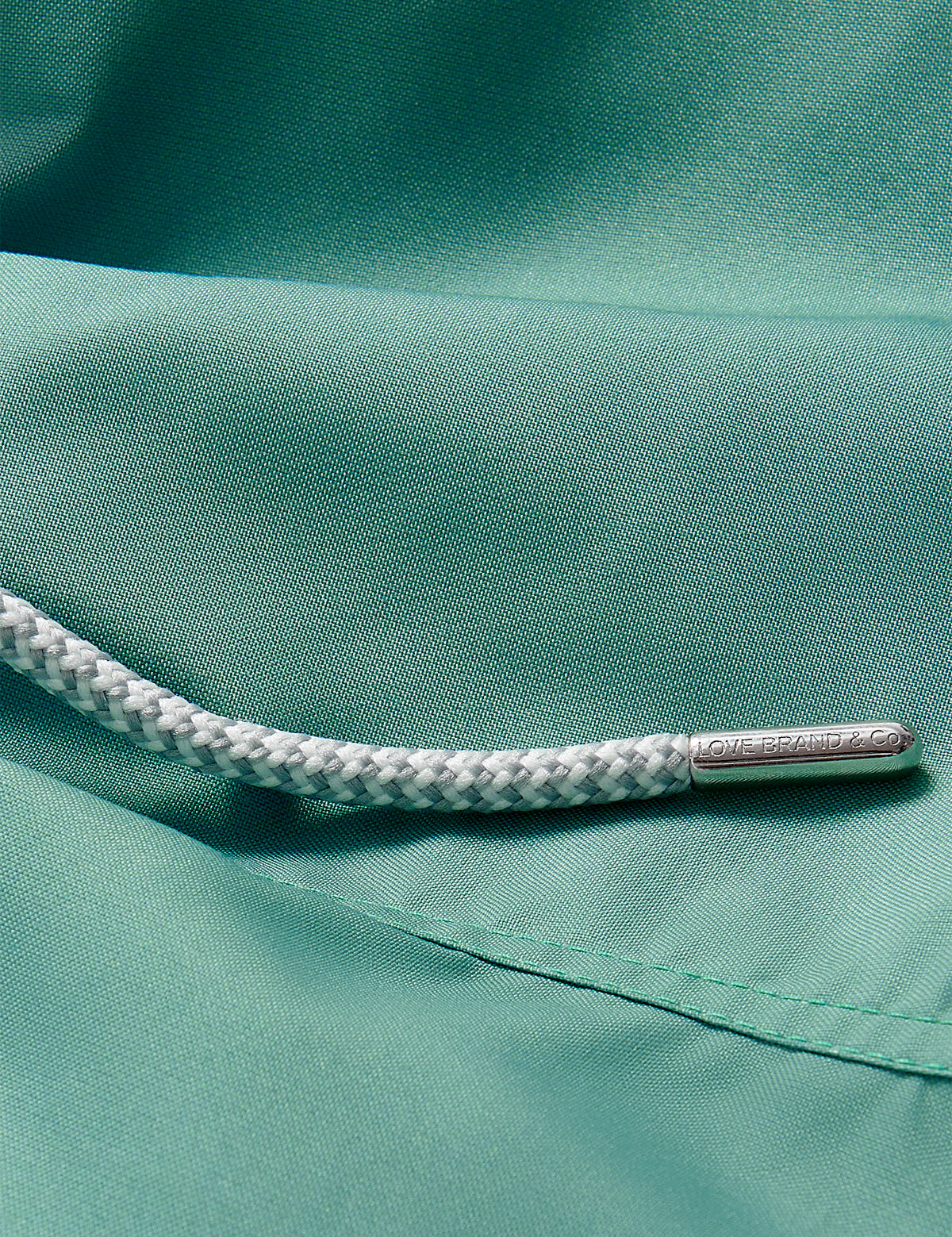 Close-up view of Boys Riviera Green Staniel Swim Shorts detailing quick-dry fabric and drawstring.