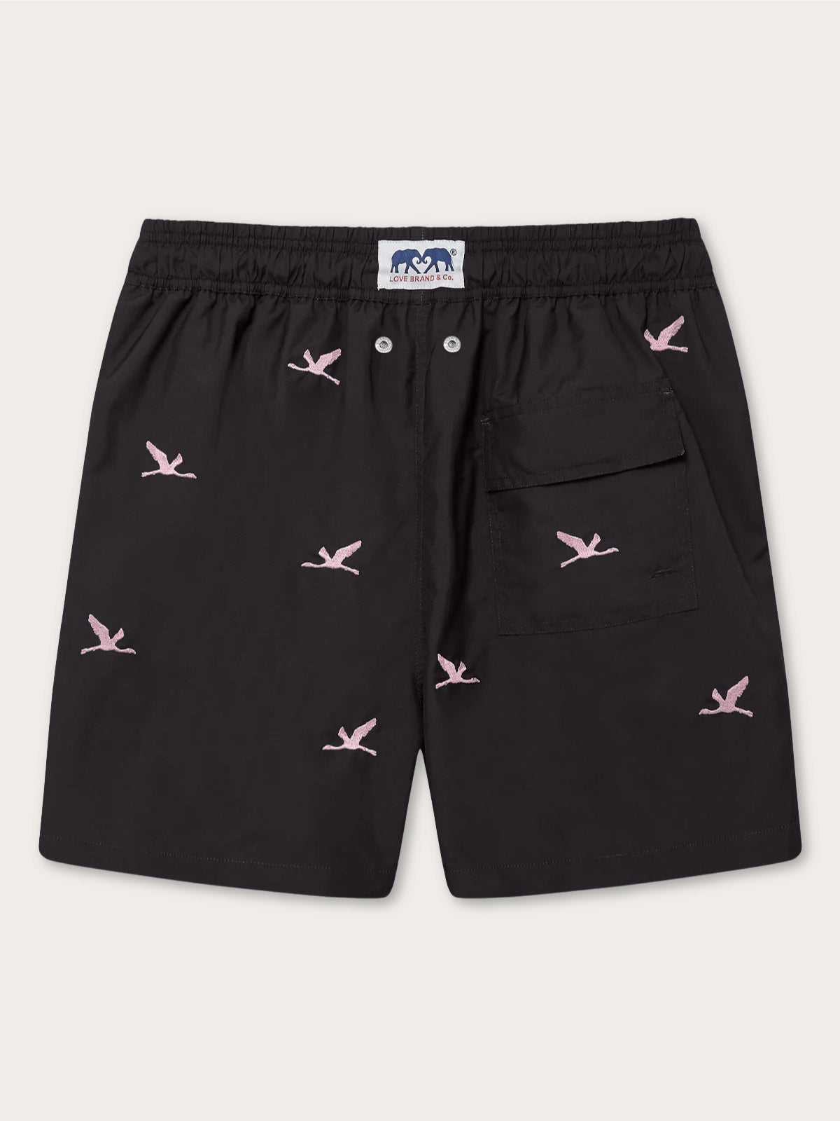 Men's Lake Nakuru Embroidered Staniel Swim Shorts with pink flamingo embroidery and a side pocket. Patterned swim shorts made from 100% recycled quick-drying fabric in black.