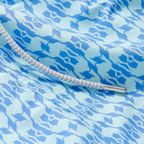 Close-up view of Boys Camel Mirage Sky Staniel Swim Shorts with a blue and white mirage pattern, highlighting the bespoke design celebrating Cop28 in Dubai 2023.