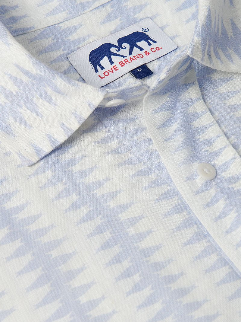 Close-up of Men's Dishy Fishy Abaco Linen Shirt featuring a chic print of a school of fish in serene blue and white hues.