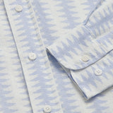 Close-up of Dishy Fishy Abaco men's Linen Shirt, featuring a serene blue and white fish pattern with white buttons, crafted from breathable 100% linen.