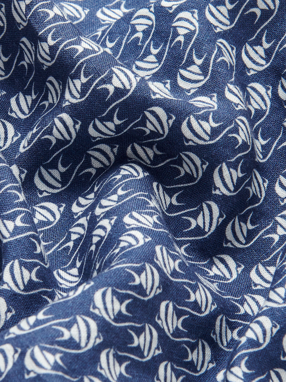 Close-up view of deep blue linen fabric with unique white Moorish Idol fish print for Men's Go With the Flow Joulter Linen Shorts.