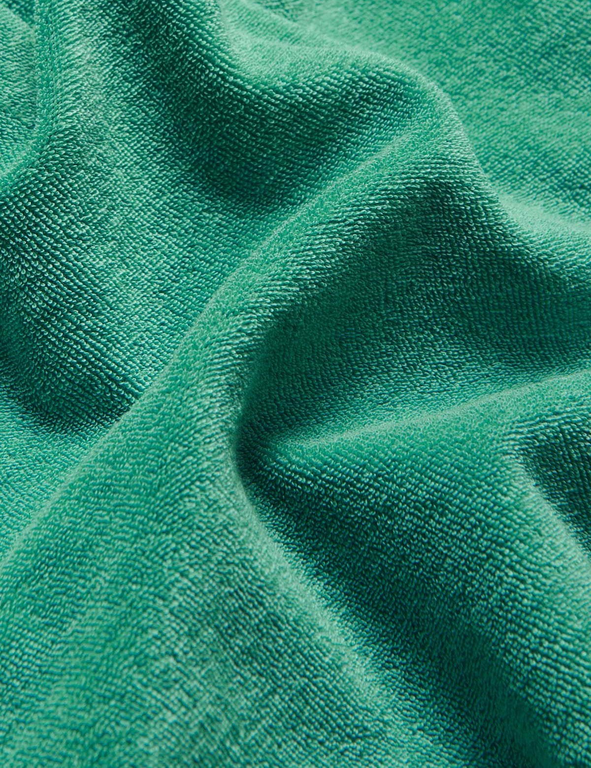 Close-up texture of the Men's Riviera Green Holmes Terry Shorts made from 100% organic cotton.