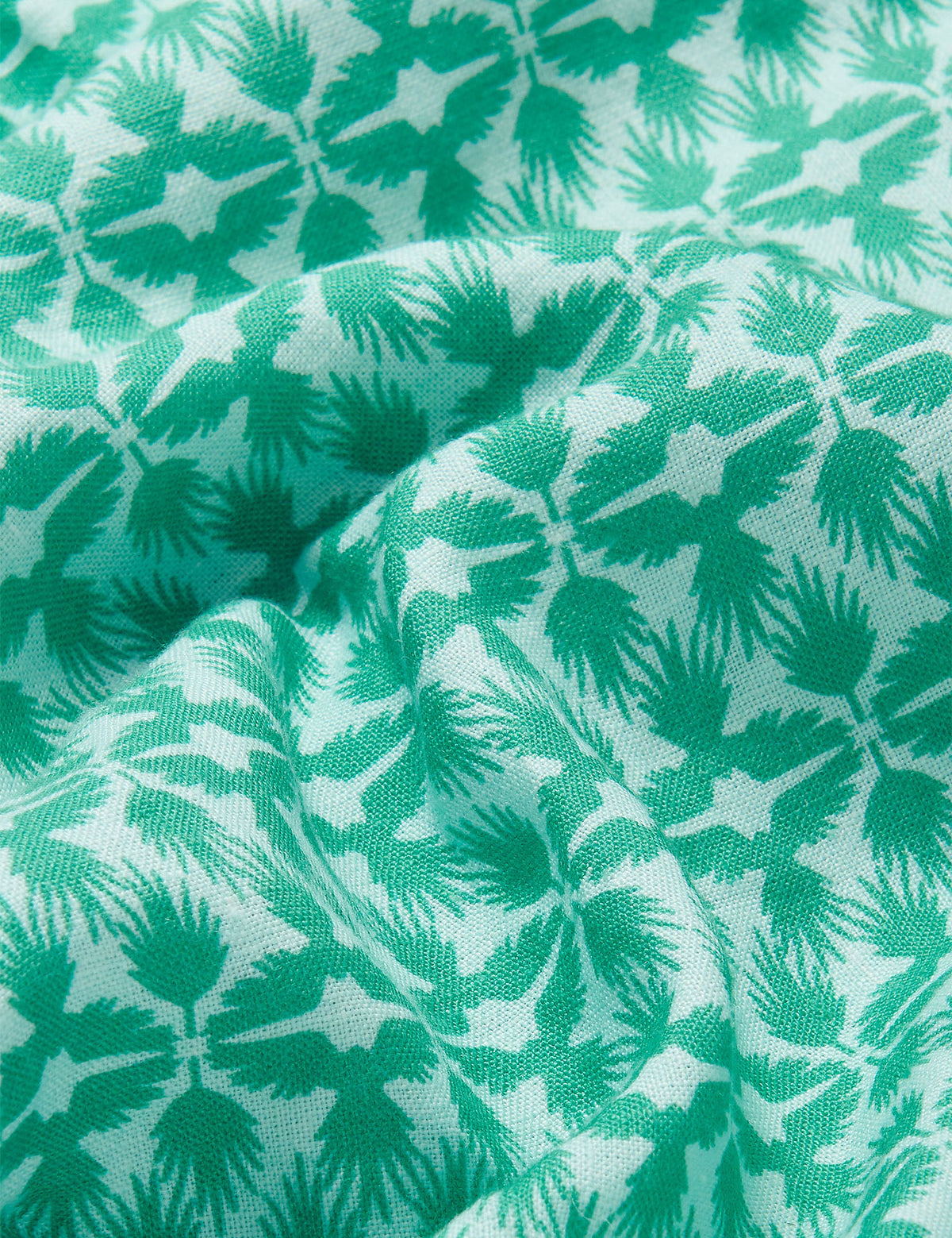 Close-up view of the green and white tropical palm and eagle pattern on the Men's Palm Eagle Joulter Linen Shorts.