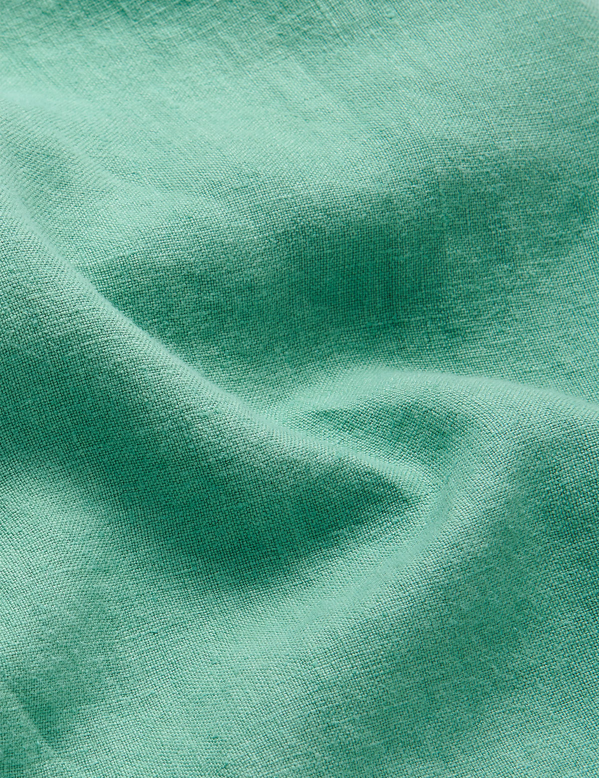 Close-up of the fabric texture of the Men's Riviera Green Burrow Linen Shorts, showcasing the lightweight and breathable 100% linen material.