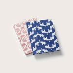 Set of two eco-friendly notebooks with block-printed cotton covers featuring 'Elephant Palace' and 'Elephants of India' prints, one with a pink design and the other with a blue design.