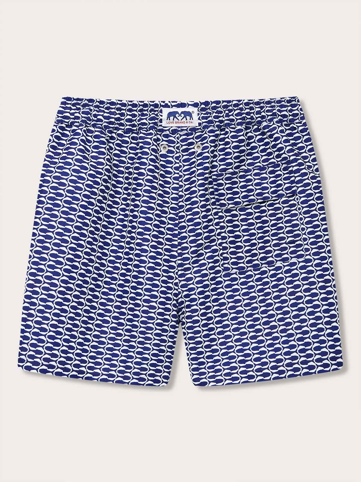 Men's Pine Cay Fish Staniel Swim Shorts with navy blue geometric fish pattern. Patterned swim shorts inspired by Pine Cay's marine ecosystem, exclusive to Pine Cay Resort and LOVE BRAND & Co.