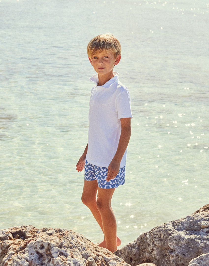 Love brand childrens swimwear brand. Model wears boys elephant palace blue swim shorts.