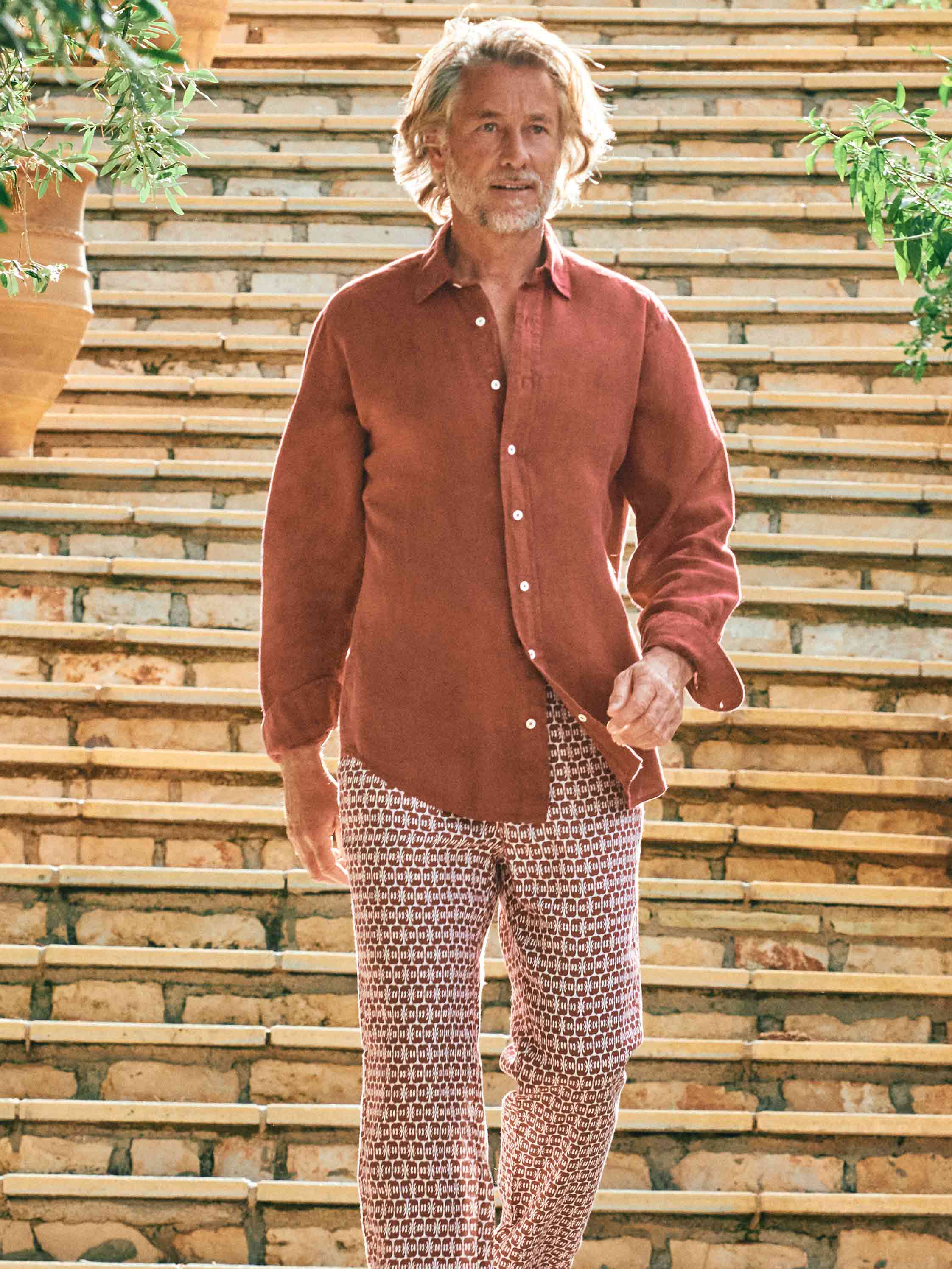 model wear mens red linen shirt paired with red patterned linen trousers